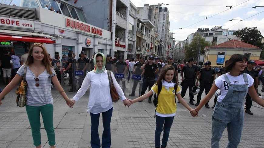 Demonstrators form a human chain in front of security forces during a peace day rally at Taksim square in central Istanbul September 1, 2013.  REUTERS/Osman Orsal (TURKEY - Tags: CIVIL UNREST POLITICS) - RTX133II