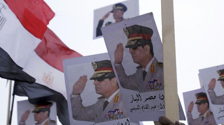 Posters of Army Chief General Abdel Fattah al-Sisi are seen as supporters of the army protest against ousted Islamist President Mohamed Mursi and members of the Muslim Brotherhood at the tomb of late Egyptian President Anwar Sadat, during the 40th anniversary of Egypt's attack on Israeli forces in the 1973 war, at Cairo's Nasr City district, October 6, 2013.  REUTERS/Amr Abdallah Dalsh  (EGYPT - Tags: POLITICS CIVIL UNREST MILITARY ANNIVERSARY) - RTR3FNL0