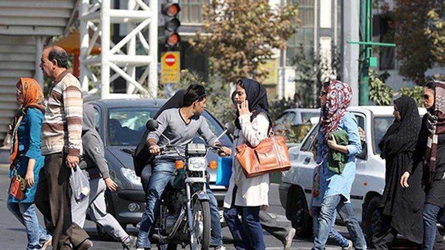 Iranian women, all wearing headscarves in line with strict Islamic rules imposed after the 1979 revolution which gave birth to the Islamic republic following the overthrow of the pro-West monarchy in Iran, cross a street central Tehran on October 17, 2013. Washington and Tehran were upbeat after Iran agreed to hold fresh nuclear talks next month and made a "breakthrough" proposal to allow spot checks on its nuclear sites. AFP PHOTO/ATTA KENARE        (Photo credit should read ATTA KENARE/AFP/Getty Images)