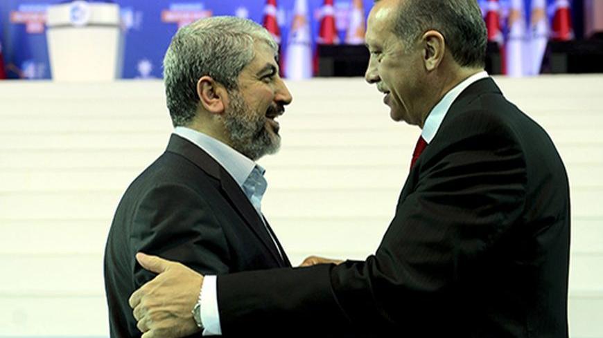 Turkey's Prime Minister and leader of ruling Justice and Development Party (AKP) Tayyip Erdogan (R) welcomes his guest Hamas leader Khaled Meshaal during the AKP congress in Ankara September 30, 2012. Erdogan trumpeted Turkey's credentials as a rising democratic power on Sunday, saying his Islamist-rooted ruling party had become an example to the Muslim world after a decade in charge. Addressing thousands of party members and regional leaders at a congress of his Justice and Development (AK) Party, Erdogan 