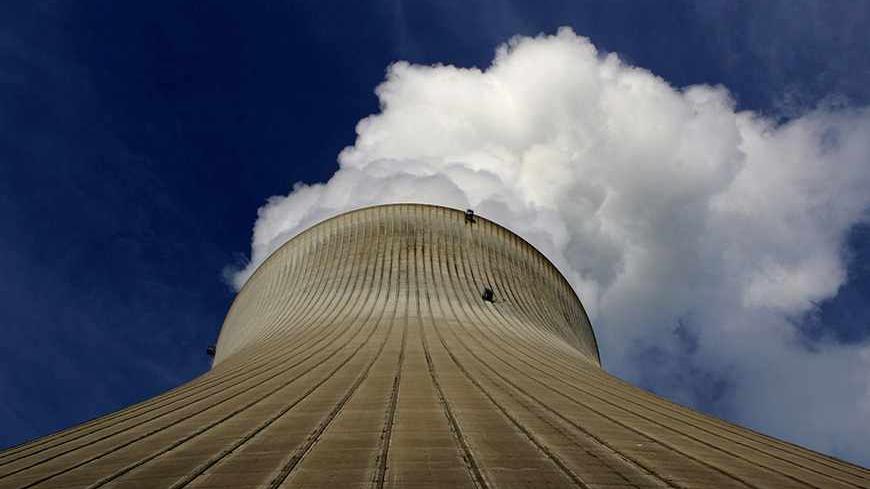 A file picture shows the cooling tower of the nuclear power plant in the Swiss town of Leibstadt some 50 kilometres (31 miles) north-west of Zurich January 7, 2005. Picture taken January 7, 2005.  REUTERS/Stefan Wermuth/Files (SWITZERLAND - Tags: ENERGY POLITICS) - RTR2JYEZ