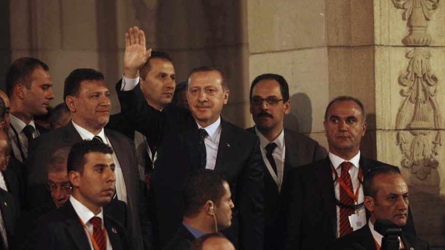 Turkish Prime Minister Tayyip Erdogan waves to students after his speech at Cairo University, on the first day of his two-day trip to Egypt, November 17, 2012. Erdogan, an outspoken of critic of Israel, praised Egypt's Islamist president, Mohamed Mursi, on Saturday for recalling his ambassador from Tel Aviv in response to Israeli attacks on Gaza. REUTERS/Asmaa Waguih (EGYPT - Tags: POLITICS CIVIL UNREST EDUCATION) - RTR3AJEO