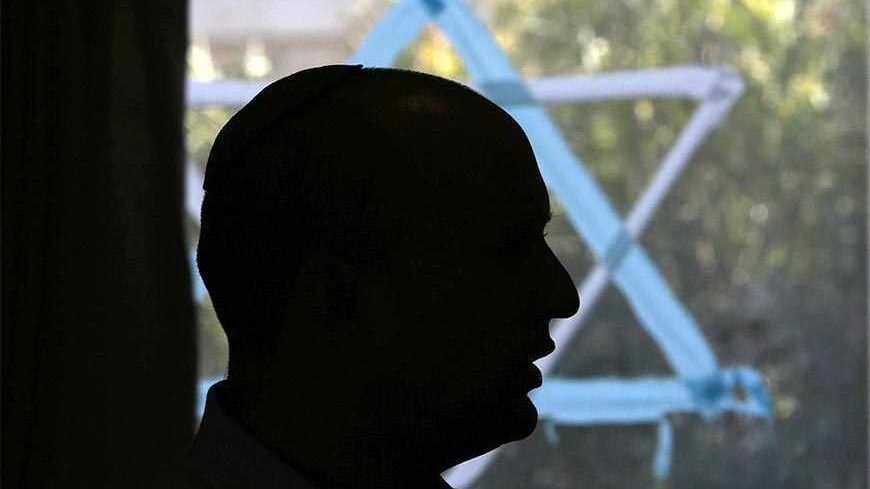 Naftali Bennett, head of the far-right Bayit Yehudi party, is silhouetted as he talks to students at a pre-army training course as he campaigns in the Shapira Center near the southern city of Ashkelon January 20, 2013. Israel will hold a parliamentary election on January 22. Bennett has emerged as the surprise success story of the country's election campaign, with polls predicting his party will win some 13 seats, and that a cabinet post for Bennett is likely. REUTERS/Baz Ratner (ISRAEL - Tags: POLITICS ELE