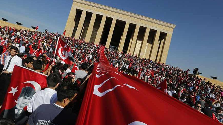 People with the national flags visit Anitkabir, mausoleum of the founder of secular Turkey Mustafa Kemal Ataturk, in central Ankara October 29, 2013. Thousands of people gathered for a march in the Turkish capital of Ankara on Tuesday to mark the 90th anniversary of the Republic Day. REUTERS/Umit Bektas (TURKEY - Tags: POLITICS ANNIVERSARY) - RTX14SLN