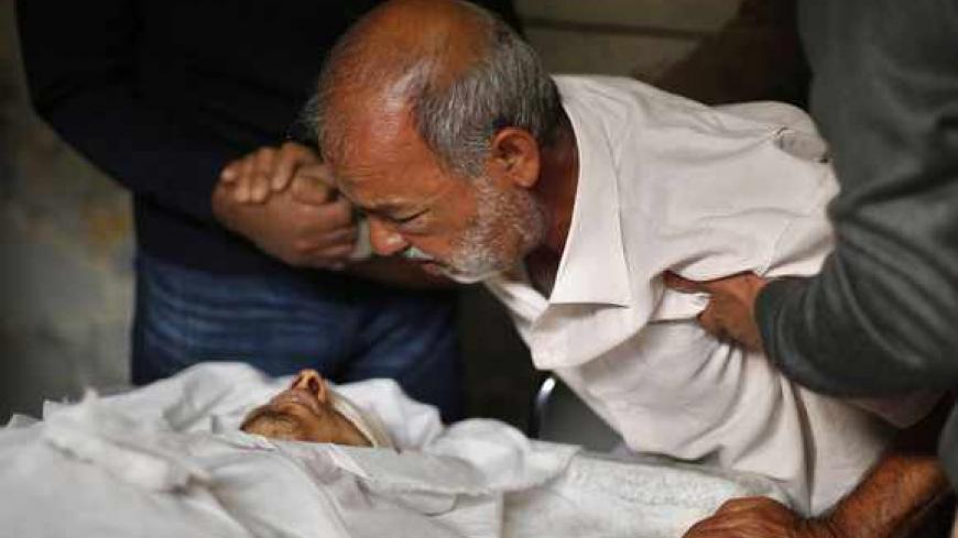 A Palestinian relative of Hamas militant Rabee Baraka mourns as he takes a farewell look at Baraka's body, at a hospital in Khan Younis in the southern Gaza Strip November 1, 2013. On Thursday, Baraka was killed and five Israeli soldiers wounded in a clash that broke out after Israeli forces detonated part of a different Gaza tunnel. Hamas said it had dug the tunnel, which Israel said ran into its territory and was intended for carrying out attacks on its soldiers and civilians. Separately, an Israeli air s