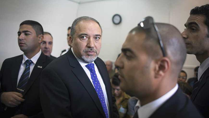 Former Israeli Foreign Minister Avigdor Lieberman (2nd L) waits to hear the verdict in the corruption charges against him at the Magistrate Court in Jerusalem November 6, 2013. Lieberman will return to the cabinet after his acquittal in a corruption trial on Wednesday, Prime Minister Benjamin Netanyahu said. REUTERS/Emil Salman/Pool (JERUSALEM - Tags: POLITICS CRIME LAW) - RTX15212