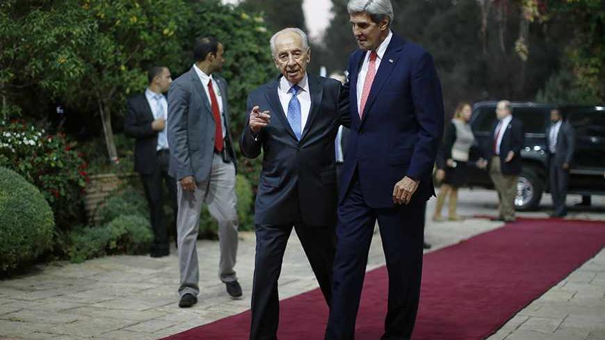 U.S. Secretary of State John Kerry walks with Israel's President Shimon Peres (L) in Jerusalem, November 6, 2013. Kerry urged Israel on Wednesday to limit settlement building in occupied territories to help push peace talks with the Palestinians back on track. REUTERS/Jason Reed   (JERUSALEM - Tags: POLITICS) - RTX152FC