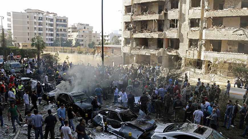 Soldiers, policemen and medical personnel gather at the site of explosions near the Iranian embassy (L) in Beirut November 19, 2013. Two explosions targeting the Iranian embassy hit the Lebanese capital Beirut on Tuesday, security sources said, killing at least seven people and damaging buildings in the embassy compound.     REUTERS/ Mohamed Azakir    (LEBANON - Tags: CIVIL UNREST POLITICS MILITARY TPX IMAGES OF THE DAY) - RTX15JOF