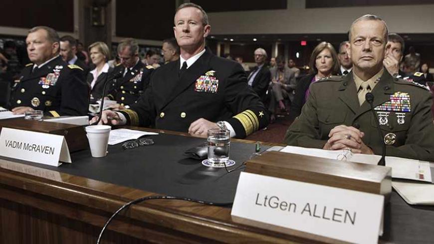 U.S. Marine Corps Lt. Gen. John Allen (R) waits to testify, as he sits next to Navy Vice Admiral William McRaven (C) and Army General James Thurman (L), before the Senate Armed Services Committee hearing on his nomination to serve as the next commander of the International Security Assistance Force (ISAF) in Afghanistan, on Capitol Hill in Washington June 28, 2011. REUTERS/Yuri Gripas (UNITED STATES - Tags: POLITICS MILITARY) - RTR2O7DR