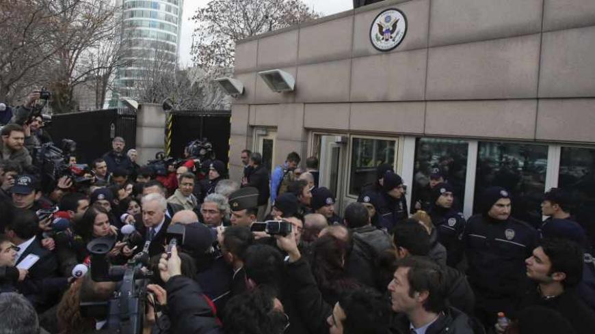 U.S. Ambassador to Turkey Francis Ricciardone (L, with white hair) speaks to media outside of the U.S. Embassy in Ankara February 1, 2013. A suicide bomber from a far-left group killed a Turkish security guard at the U.S. embassy in Ankara on Friday, blowing the door off a side entrance and sending smoke and debris flying into the street. The attacker blew himself up inside U.S. property, Ankara Governor Alaaddin Yuksel said. The blast sent masonry spewing out of the wall and could be heard a mile away. REU