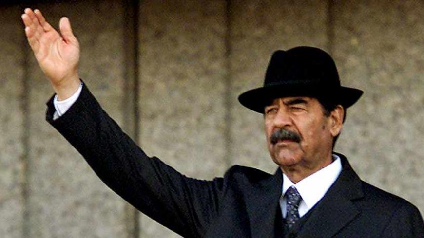 The U.S. military has apparently captured former Iraqi President Saddam Hussein in a raid in his home town of Tikrit, a defense official said on December 14, 2003. This December 31, 2001 file photo shows Iraqi President Saddam Hussein waving to a crowd in Baghdad. REUTERS/Faleh Kheiber  SJS/CMC - RTR8RO2