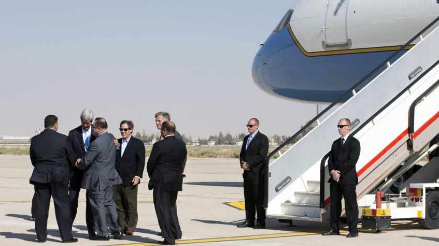 U.S. Secretary of State John Kerry (2nd L) says goodbye to officials before boarding his plane to return to Israel, in Amman June 29, 2013. Kerry extended his Middle East peace mission on Saturday, shuttling between Jerusalem and Amman for more talks with Israeli and Palestinian leaders on reviving their stalled negotiations. REUTERS/Jacquelyn Martin/Pool (JORDAN - Tags: POLITICS) - RTX116CF
