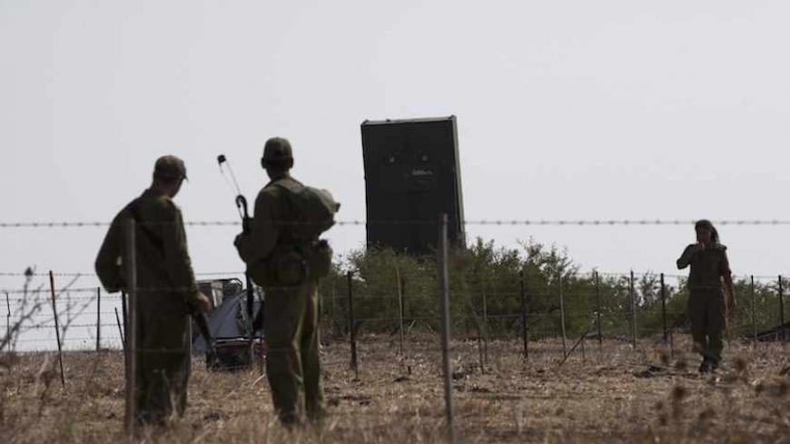 Israeli soldiers stand near an air defence radar deployed in northern Israel August 29, 2013. Israel ordered a small-scale mobilisation of reservists on Wednesday and strengthened its missile defences as precautions against possible Syrian attack should Western powers carry out threatened strikes on Syria. Israel remains technically at war with Syria, which has long demanded an Israeli withdrawal from the strategic Golan Heights, land that Israel captured in a 1967 war. REUTERS/Ronen Zvulun (ISRAEL - Tags: 