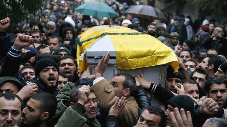 Lebanon's Hezbollah members and relatives carry the coffin of commander Hassan al-Laqqis during his funeral in Baalbeck, in Lebanon's Bekaa valley December 4, 2013. Al-Laqqis, a Hezbollah commander who fought in Syria's civil war was shot dead outside his home in Lebanon on Wednesday in an attack which the militant Shi'ite group blamed on Israel. Israel denied any role in the killing of Hassan al-Laqqis, who was shot from close range by a silenced gun as he arrived home at around midnight in the Hadath dist