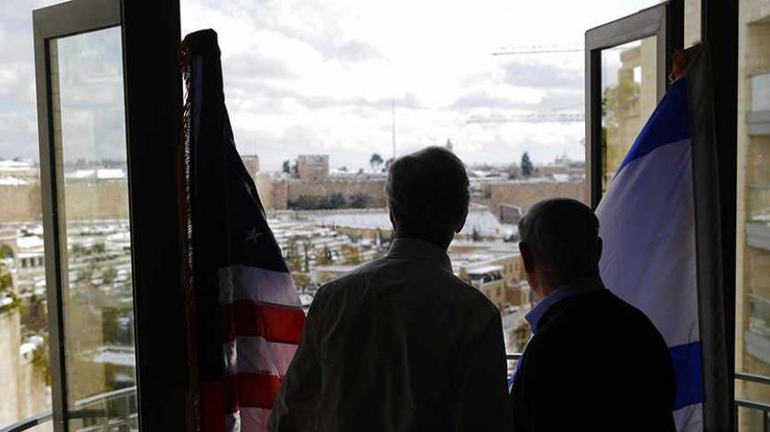 U.S. Secretary of State John Kerry (L) and Israeli Prime Minister Benjamin Netanyahu look out onto the snow covered city of Jersusalem, during a meeting, December 13, 2013. REUTERS/Brian Snyder (JERUSALEM - Tags: POLITICS) - RTX16GG2