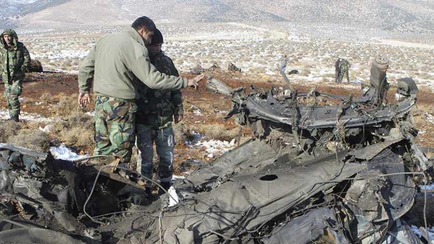 Members of the Lebanese army security inspect the explosion site east of Baalbeck city in Lebanon's Bekaa valley, December 17, 2013. An explosives-laden car blew up on Tuesday in a remote region of the Bekaa Valley controlled by Lebanon's Shi'ite Hezbollah movement, killing the driver and wounding at least two people who were pursuing the vehicle, security sources said. REUTERS/Ahmad Shalha (LEBANON - Tags: POLITICS CIVIL UNREST) - RTX16LYD