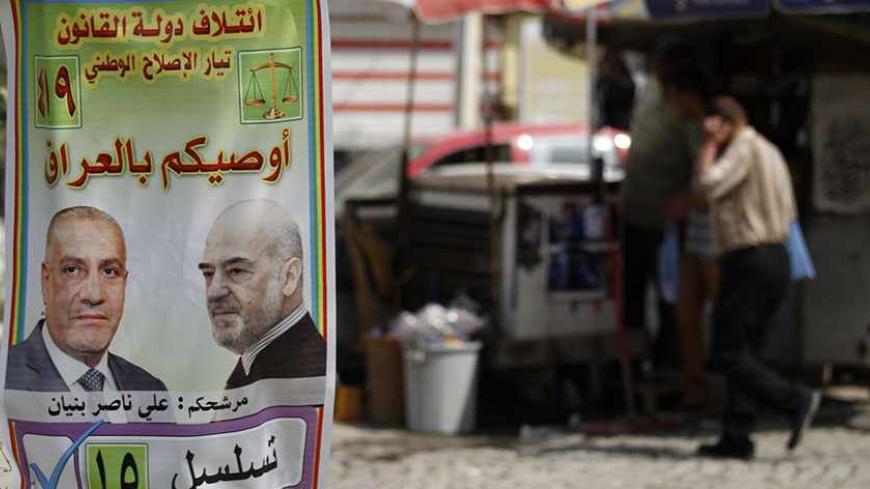 An Iraqi walks past a provincial elections campaign poster in Baghdad, April 18, 2013. Iraq will hold its provincial elections on Saturday. The poster reads, "take care of Iraq". REUTERS/Mohammed Ameen (IRAQ - Tags: SOCIETY POLITICS ELECTIONS) - RTXYQSM