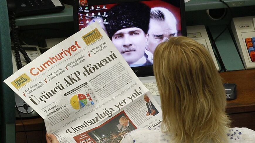 A trader reads a newspaper with the headline that reads "AK Party Term", during the morning session at the Istanbul Stock Exchange June 13, 2011. Turkish stocks rose on Monday after Prime Minister Tayyip Erdogan's AK Party won Sunday's parliamentary election to secure a third term of single-party rule. The AK Party won 50 percent of the vote to give Erdogan a third consecutive term. But the AK Party's parliamentary majority slipped, as it won 326 seats, down from 331 in the previous assembly. REUTERS/Murad 