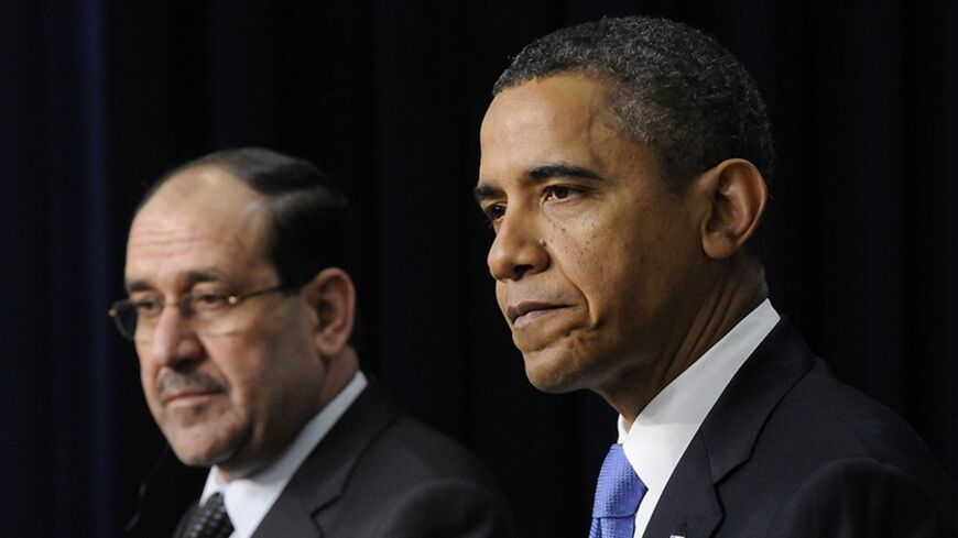 Iraq's Prime Minister Nuri al-Maliki (L) and U.S. President Barack Obama (R) listen to questions during a joint news conference in the Eisenhower Executive Office Building on the White House campus in Washington, December 12, 2011. REUTERS
Jonathan Ernst   (UNITED STATES - Tags: POLITICS) - RTR2V679