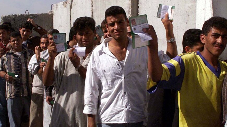 Palestinians displays their I.D cards as they stand in line waiting to get their special safe passage cards in front of the safe passage office at Erez in the Gaza Strip November 2. On Tuesday Israel for the first time gave Palestinians who were previously not allowed to use the safe passage route for the security reasons, the special "safe passage cards" which will enable them to travel in buses between Gaza and West Bank under the guard of Israeli soldiers. aj/ Photo by Ahmed Jadallah.

AJ/AA - RTRS07Y