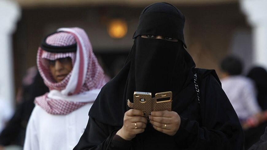 A woman using an iPhone visits the 27th Janadriya festival on the outskirts of Riyadh in this February 13, 2012 file photo. Saudi Telecom Co (STC) is a company with a market capitalisation of $21 billion but no permanent chief executive. It has spent billions of dollars to buy foreign assets, but competitive pressures may force it to focus more on domestic business. Annual profits at Saudi Arabia's biggest telecommunications operator have fallen 43 percent from their 2006 peak, and its part-privatisation ha