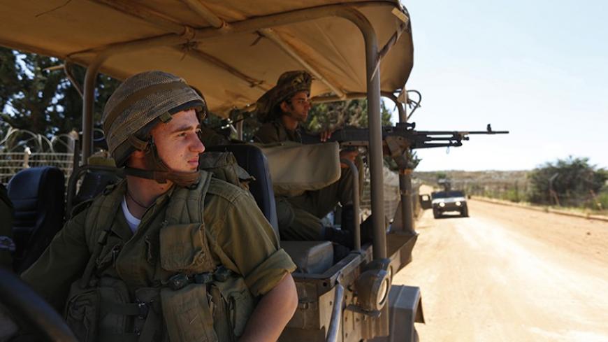 Israeli soldiers ride an army jeep during a patrol along Israel's border with Lebanon near the northern village of Avivim July 3, 2013. Israel is bolstering its forces on the once-quiet frontier with Syria where it believes Lebanese Hezbollah militants are preparing for the day when they could fight Israel. Picture taken July 3, 2013. REUTERS/Baz Ratner (ISRAEL - Tags: MILITARY POLITICS) - RTX11IMI