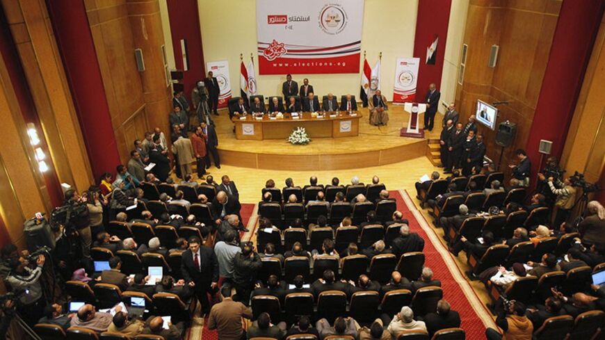 A general view shows a news conference, held by Supreme Election Committee head Nabil Salib (C) to announce a new constitution, in Cairo January 18, 2014. More than 98 percent of voters backed the new Egyptian constitution in a referendum this week, authorities said on Saturday, though the turnout was lower than some officials had indicated, with under 40 percent of the electorate taking part. REUTERS/ Mohamed Abd El Ghany (EGYPT - Tags: POLITICS) - RTX17JWD