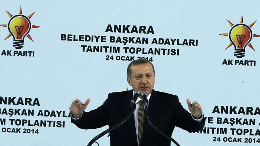 Turkey's Prime Minister Tayyip Erdogan addresses his supporters during a meeting of the ruling AK Party (AKP) in Ankara January 24, 2014. Turkey received a vote of confidence in its underlying economic health on Thursday, with foreign investors lapping up a $2.5 billion eurobond issue even as a corruption scandal swirled and the central bank intervened to prop up the lira. The graft investigation, one of the biggest threats to Erdogan's 11-year rule, has shaken Turkey in recent weeks, helping send the lira 