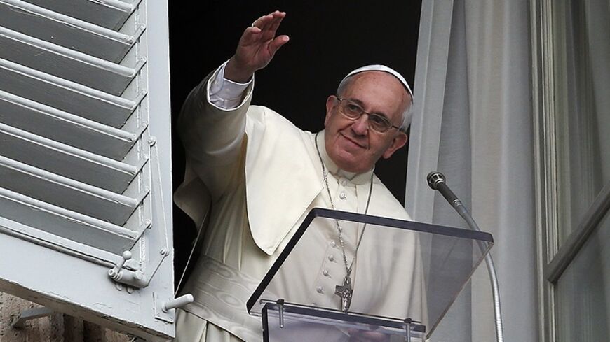 Pope Francis waves before releasing doves during the Angelus prayer in Saint Peter's square at the Vatican January 26, 2014. 
REUTERS/Alessandro Bianchi (VATICAN - Tags: RELIGION) - RTX17V3O