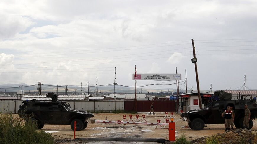 Turkish soldiers with armoured vehicles guard the entrance of Apaydin refugee camp in Hatay province, on the Turkish-Syrian border, May 12, 2013. Turkey accused a group loyal to Syrian President Bashar al-Assad on Sunday of carrying out car bombings that killed 46 people in a Turkish border town of Reyhanli and said the risk of unrest spreading to Syria's neighbours was increasing. Syrian Information Minister Omran Zubi denied any Syrian involvement and rejected what he called "unfounded accusations". REUTE