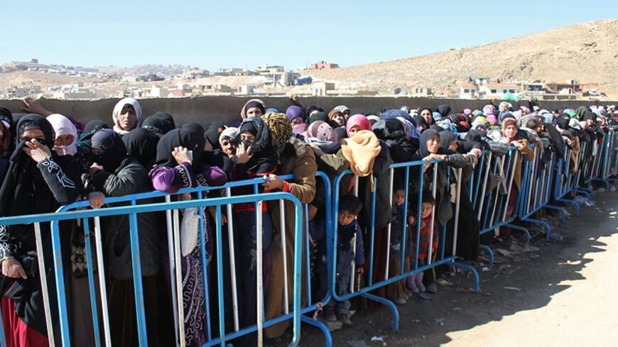 Syrian families queue to be registered by the United Nations High Commissioner for Refugees (UNHCR) on February 18, 2014 in the Arsal refugee camp in the Lebanese Bekaa valley. More than 130,000 people have been killed since the uprising against President Bashar al-Assad began in March 2011, and millions more have been displaced in what UN officials have described as the worst refugee crisis in two decades. AFP PHOTO / STR        (Photo credit should read -/AFP/Getty Images)