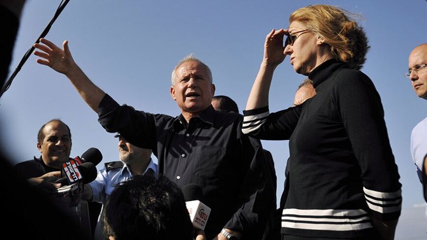 Israel's Foreign Minister Tzipi Livni (3rd R) and Minister of Internal Security Avi Dichter (4th R) speak to the media during a visit to an observation point that overlooks Gaza, near Kibbutz Zikim just outside the Gaza Strip, December 9, 2008. REUTERS/Amir Cohen (ISRAEL) - RTR22EZN