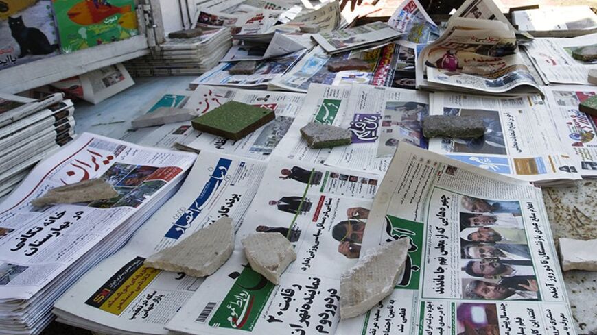 EDITORS' NOTE: Reuters and other foreign media are subject to Iranian restrictions on leaving the office to report, film or take pictures in Tehran.
A man looks at newspapers at a news stand in Tehran March 4, 2012. Hardliners allied with Iran's Supreme Leader Ayatollah Ali Khamenei maintained their lead in the country's parliamentary vote, with partial results on Sunday showing supporters of the president trailing behind. REUTERS/Raheb Homavandi  (IRAN - Tags: POLITICS ELECTIONS) - RTR2YTIX