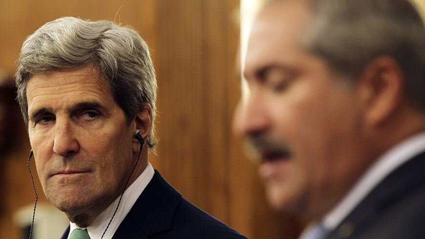 U.S. Secretary of State John Kerry (L) listens to Jordan's Foreign Minister Nasser Judeh during their joint news conference at the Ministry of Foreign Affairs in Amman November 7, 2013. REUTERS/Muhammad Hamed (JORDAN - Tags: POLITICS) - RTX153X6