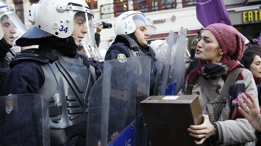 An activist for women's rights argues with riot police during a protest in Istanbul January 5, 2014. The activists, which included relatives of victims of domestic violence, were halted by riot police during their march along the main pedestrian street of Istiklal in central Istanbul. REUTERS/Murad Sezer (TURKEY - Tags: POLITICS CIVIL UNREST) - RTX172YV