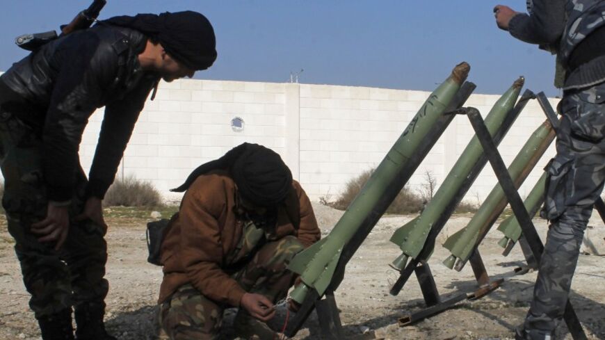 Fighters from the Free Syrian Army's Saif al-Umayyad brigade prepare rockets to be launched towards forces loyal to Syria's President Bashar al-Assad in the eastern Damascus suburb of Ghouta January 16, 2014. Picture taken January 16, 2014. REUTERS/Rafat Beram (SYRIA - Tags: CIVIL UNREST CONFLICT) - RTX17I18
