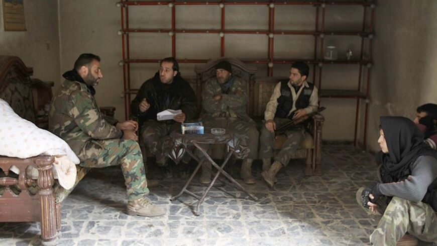 Free Syrian Army fighters sit inside a room as they chat near Aleppo's historic citadel, which is controlled by forces loyal to Syria's President Bashar al-Assad February 10, 2014. Picture taken February 10, 2014. REUTERS/Ammar Abdullah (SYRIA - Tags: POLITICS CIVIL UNREST CONFLICT) - RTX18L1O