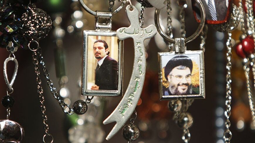 Pictures of Lebanon's Hezbollah leader Sayyed Hassan Nasrallah (R) and Lebanese caretaker Prime Minister Saad al-Hariri are seen on key rings at a gift shop in the port city of Sidon, southern Lebanon, January 19, 2011. Saudi Arabia has abandoned its mediation efforts in Lebanon, saying the situation was "dangerous," Al Arabiya television said on Wednesday, citing Foreign Minister Prince Saud al-Faisal. REUTERS/ Ali Hashisho   (LEBANON - Tags: POLITICS) - RTXWRZE