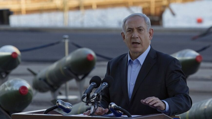 Israel's Prime Minister Benjamin Netanyahu speaks to the media in front of a display of M302 rockets, found aboard the Klos C ship, at a navy base in the Red Sea resort city of Eilat March 10, 2014. Netanyahu, displaying on Monday what Israel said were seized Iranian-supplied missiles bound for militants in Gaza, called on the West not to be fooled by Tehran's diplomatic outreach over its nuclear programme. REUTERS/Amir Cohen (ISRAEL - Tags: POLITICS MILITARY CIVIL UNREST) - RTR3GGS8