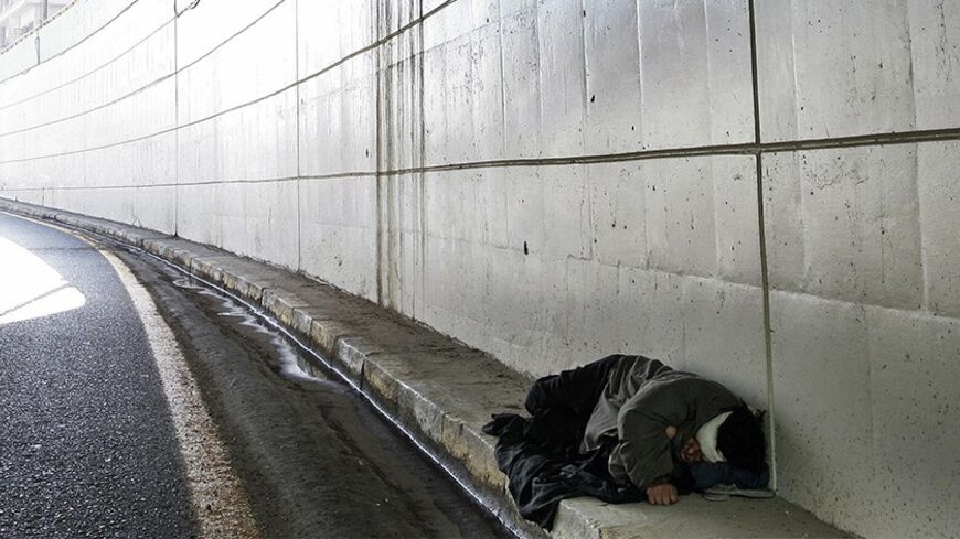 An Iraqi homeless person sleeps inside a street tunnel in central Baghdad, 14 November 2007. A roadside bomb attack targeting a US patrol near Baghdad's heavily fortified Green Zone killed today two Iraqi civilians and wounded three, security officials said. AFP PHOTO/SABAH ARAR (Photo credit should read SABAH ARAR/AFP/Getty Images)