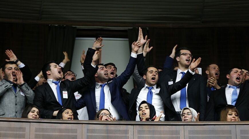 Supporters of Turkey's Prime Minister Tayyip Erdogan react as he addresses the audience during a meeting at the Turkish parliament in Ankara February 25, 2014. Erdogan said on Tuesday voice recordings purportedly of him telling his son to dispose of large sums of money on the day news broke of a graft inquiry were a "treacherous attack" on his office. In a speech to his ruling AK Party deputies in parliament, Erdogan also said the recordings, which appeared on YouTube late on Monday, were a "shameless monta