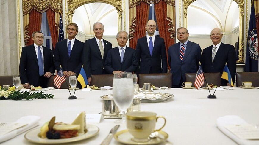 Ukraine's Prime Minister Arseniy Yatseniuk (3rd R) poses for pictures at a meeting with members of the U.S. Senate Foreign Relations Committee, including chairman Senator Bob Menendez (D-NJ) (2nd R) and ranking member Senator Bob Corker (R-TN) (4th L) at the U.S. Capitol in Washington March 12, 2014.  REUTERS/Jonathan Ernst    (UNITED STATES - Tags: POLITICS) - RTR3GUH1