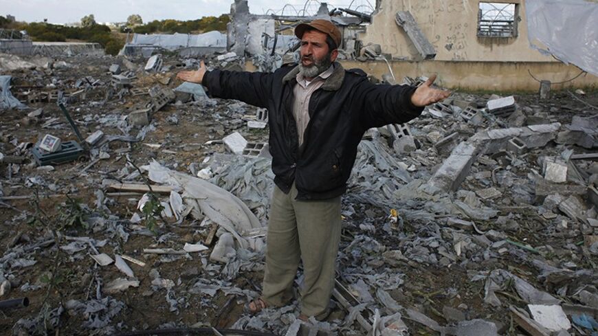 A Palestinian man gestures as he inspects the scene of an Israeli air strike in Rafah in the southern of Gaza Strip March 14, 2014. A small armed faction in the Gaza Strip fired rockets at Israel on Thursday, drawing retaliatory air strikes and pushing cross-border violence into a third day despite a truce called by the more powerful Palestinian group Islamic Jihad. REUTERS/Ibraheem Abu Mustafa (GAZA - Tags: POLITICS CIVIL UNREST) - RTR3H1MY