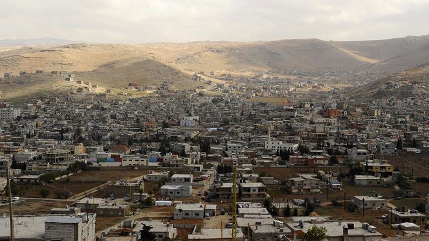 A general view shows the Sunni Muslim border town of Arsal, in eastern Bekaa Valley March 19, 2014. The Lebanese army reopened a road between two towns near the Syrian border on Wednesday to try to calm sectarian rivalry aggravated by the conflict in neighbouring Syria. Shi'ite Muslims from the Bekaa Valley town of al-Labwa, where Hezbollah has strong support, had erected sandbag barriers at the weekend to cut off the Sunni Muslim town of Arsal from the rest of Lebanon. REUTERS/Hassan Abdallah (LEBANON - Ta