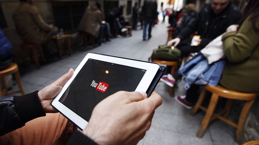 A man tries to get connected to the youtube web site with his tablet at a cafe in Istanbul March 27, 2014. The Turkish telecoms authority TIB said on Thursday it had taken an "administrative measure" against YouTube, a week after it blocked access to microblogging site Twitter. REUTERS/Osman Orsal (TURKEY - Tags: POLITICS CIVIL UNREST SCIENCE TECHNOLOGY) - RTR3IUSP