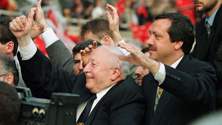 Turkey's Islamist Prime Minister Necmettin Erbakan flanked by Istanbul Mayor Recep Tayyip Erdogan (R) gives a thumbs-up sign to the cheering 30,000-strong crowd gathered in Istanbul's central Inonu stadium May 29 to celebrate the 544th anniversary of the Ottoman conquest of Istanbul. Turkey's ruling Islamists said today no definite decision had been taken to go to early elections or hand over power to Foreign Minister Tansu Ciller in talks between the coalition allies to solve a political crisis.

TURKEY - 