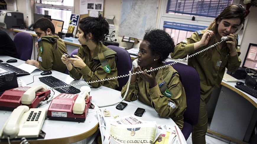 Israeli soldiers from Galei Tzahal, the Israeli army radio station, work in the newsroom at the station's studios in Jaffa, south of central Tel Aviv November 10, 2013. The Israeli military operates two radio stations, a news-based station that started broadcasting in 1950, and Galgalatz, a popular music station marking its 20th anniversary. The stations mostly employ soldiers who work alongside civilian presenters, including leading names in Israeli broadcasting. Picture taken November 10, 2013. REUTERS/Ni
