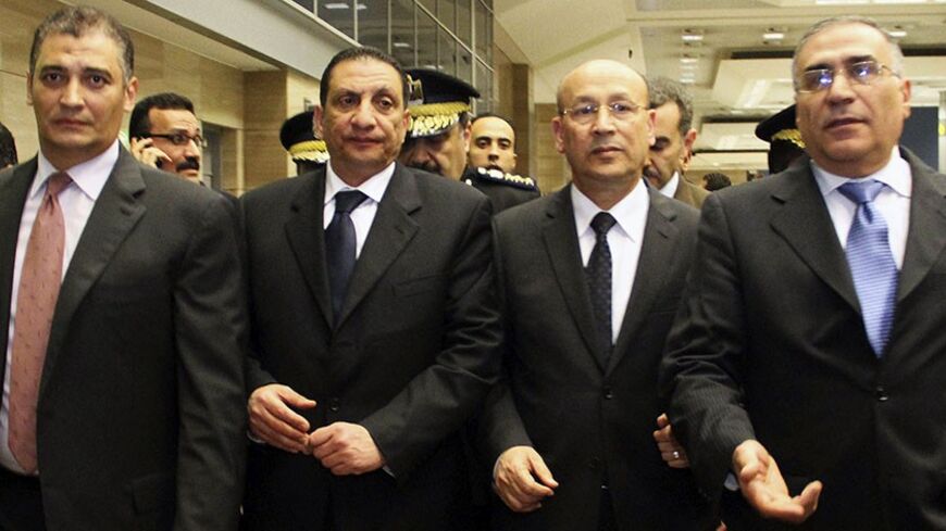 Kidnapped Egyptian diplomats who were released in Libya are accompanied by Egyptian officials as they arrive at Cairo's airport, January 27, 2014. The five Egyptian diplomats kidnapped in Tripoli in retaliation for Egypt's arrest of a Libyan militia commander have been freed, Libyan Deputy Foreign Minister Abdul Razak Al-Grady said on Sunday. The abduction of diplomats in the Libyan capital illustrated the fragility of government control over former rebels and militias who two years ago helped topple Muamma
