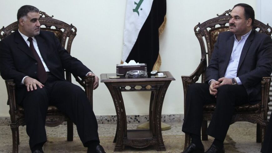 Iraq's Deputy Prime Minister Rafi Essawi (R) meets with Hassan al-Shammari, head of the Iraqi Islamic al Fadila parliamentary bloc, in Baghdad October 1, 2010. REUTERS/Mohammed Ameen (IRAQ - Tags: POLITICS) - RTXSX67