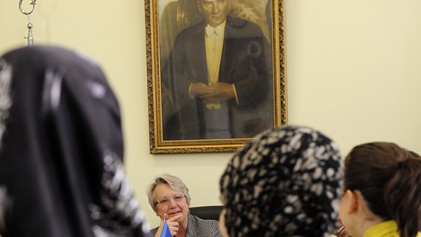 German Education Minister Annette Schavan meets students of Ankara University Faculty of Theology in Ankara October 21, 2010. A portrait of modern Turkey's founder Ataturk is seen in the background. REUTERS/Stringer (TURKEY - Tags: POLITICS RELIGION) - RTXTOG2